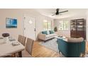 Inviting living room featuring hardwood floors, a ceiling fan, and stylish contemporary furniture at 4111 S Delaware St, Englewood, CO 80110