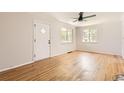 Spacious living room featuring hardwood floors, a ceiling fan, and ample natural light at 4111 S Delaware St, Englewood, CO 80110