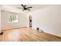 Bright living room featuring hardwood floors, neutral walls, and a modern ceiling fan at 4111 S Delaware St, Englewood, CO 80110