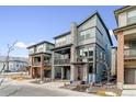 Modern two-story home with gray siding, stone accents, and balcony at 15644 W Floyd Dr, Morrison, CO 80465