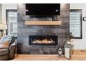 Modern gas fireplace with a sleek stone surround at 15644 W Floyd Dr, Morrison, CO 80465