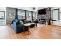 Spacious living room with hardwood floors, fireplace, and large windows at 15644 W Floyd Dr, Morrison, CO 80465