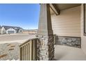 Charming front porch featuring stone and wood accents, creating a warm and inviting entryway to the home at 668 Leafy Aster Ln, Castle Rock, CO 80104