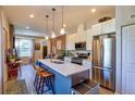 Modern kitchen with stainless steel appliances, a center island, and pendant lighting at 1739 E Martin Luther King Jr Blvd, Denver, CO 80205