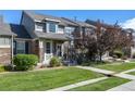 Townhome with a charming front porch and walkway at 4727 Raven Run, Broomfield, CO 80023