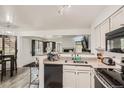 Cozy kitchen featuring sleek appliances, granite countertops, and a breakfast bar overlooking the living area at 4882 E Kentucky Ave # A, Denver, CO 80246
