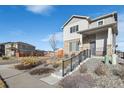 Two-story house with gray siding, stone accents, and a landscaped front yard at 6792 Longpark Dr, Parker, CO 80138