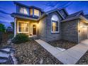 Inviting home exterior with brick facade, manicured front yard, and a welcoming entrance at 9412 Burgundy Cir, Highlands Ranch, CO 80126