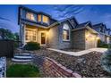 Inviting home exterior with brick facade, manicured front yard, and a welcoming entrance at 9412 Burgundy Cir, Highlands Ranch, CO 80126