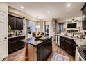 Spacious kitchen with stainless steel appliances, granite countertops, and a large center island at 9412 Burgundy Cir, Highlands Ranch, CO 80126