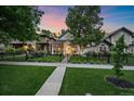 Attractive home exterior with a well-maintained lawn, mature trees, and a welcoming front entrance at 2340 S Columbine St, Denver, CO 80210