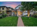 Inviting home with landscaped front yard, covered porch, and a charming pathway to the entrance at 2340 S Columbine St, Denver, CO 80210