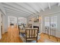 Bright living room with a fireplace, exposed beams, and hardwood floors, creating a cozy atmosphere at 2340 S Columbine St, Denver, CO 80210