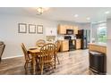Inviting dining area with wood table adjacent to kitchen at 10700 Kimblewyck Cir # 155, Northglenn, CO 80233