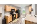 Bright kitchen featuring modern appliances and wood-style flooring at 10700 Kimblewyck Cir # 155, Northglenn, CO 80233