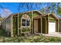 Green single-Gathering home with a white garage door and light trim at 1248 Meadow St, Longmont, CO 80501
