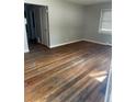 Bright living room showcasing gleaming hardwood floors, neutral paint, and ample natural light at 2625 W Ellsworth Ave, Denver, CO 80219