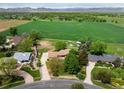 Aerial view of a home situated on a large lot with green fields and mountain views at 2117 Stonehenge Cir, Lafayette, CO 80026