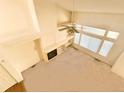 High-angle view of a living room with a fireplace, built-in shelves, and large windows at 6407 S Dallas Ct, Englewood, CO 80111