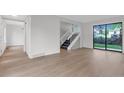 Bright, open-concept living area with new flooring and staircase at 1304 Ceres Dr, Lafayette, CO 80026