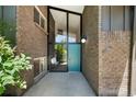 Inviting entryway with large glass panels and a stylish blue front door, enhanced by brick accents at 5265 W Quarles Dr, Littleton, CO 80128