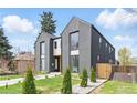 Modern two-story home featuring a gray exterior, manicured lawn, and a fenced yard at 2961 S Cherokee, Englewood, CO 80110