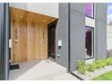 The front entrance is modern with natural wood, stylish black accents and lush landscaping at 2961 S Cherokee, Englewood, CO 80110