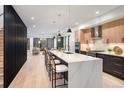 Modern kitchen featuring a large island, stainless appliances, and open floor plan at 2961 S Cherokee, Englewood, CO 80110