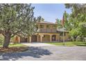 Charming two-story home with brick facade, balcony, spacious driveway, and attached two-car garage at 12196 W Belleview Dr, Littleton, CO 80127