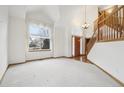 Inviting foyer features hardwood floors, high ceilings, grand staircase, and large picturesque windows at 2247 Eagles Nest Dr, Lafayette, CO 80026