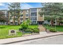 Multi-story building with well-manicured lawn and mature trees at 3022 S Wheeling Way # 107, Aurora, CO 80014