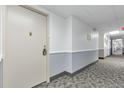 Hallway leading to units with neutral paint and carpet at 3022 S Wheeling Way # 107, Aurora, CO 80014