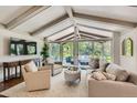 Bright living room with vaulted ceilings, large windows, comfortable seating, and access to outdoor patio at 13 Club Ln, Littleton, CO 80123