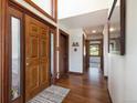 Grand foyer with hardwood floors, a decorative rug, and beautiful wood trim around doors at 6880 Kilimanjaro Dr, Evergreen, CO 80439