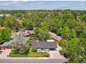 Aerial view of a charming home nestled among lush greenery with mature landscaping and a well-kept lawn at 1333 W Peakview Ave, Littleton, CO 80120