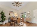 Bright dining room featuring hardwood floors, vaulted ceilings, and stylish decor, perfect for gatherings at 9698 Queenscliffe Dr, Highlands Ranch, CO 80130