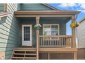 Charming front porch with hanging plants and a cozy entryway, ideal for relaxing at 9698 Queenscliffe Dr, Highlands Ranch, CO 80130