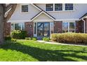 Inviting front entrance with a glass door and well-maintained landscaping at 7082 W Morraine Dr, Littleton, CO 80128