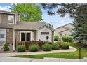 Attractive townhome with inviting front patio, sidewalk, and lush green lawn, great for outdoor living at 11565 Decatur St # 7D, Denver, CO 80234