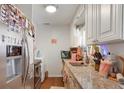Galley kitchen featuring granite counters, wood floors, and stainless steel appliances at 4961 E Cornell Ave, Denver, CO 80222