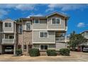 Multi-level condo with brick and siding, showcasing covered balconies and attached garages at 4947 Noble Park Pl, Boulder, CO 80301