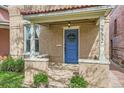 Close-up of the house front showing the blue door and flowers on the front porch at 2222 N Williams St, Denver, CO 80205