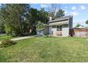 Charming single-story home with manicured lawn, front yard tree, and attached one car garage at 7629 Depew St, Arvada, CO 80003