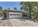 Charming single-story home featuring a brick facade, two car garage, and xeriscaped front yard at 540 Ithaca Dr, Boulder, CO 80305
