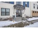Entrance of the building with snow-covered steps and a glass door at 336 E 1St Ave # 200, Denver, CO 80203