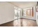 Spacious room with hardwood floors, large windows offering natural light, and minimalist design at 336 E 1St Ave # 200, Denver, CO 80203