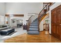 Elegant foyer showcasing hardwood floors, a staircase, and an open layout connecting to the living spaces at 8427 Pierson Ct, Arvada, CO 80005