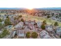 Gorgeous aerial view shows the property nestled in lush landscape with a golf course and mountain views at 2061 S Worchester Way, Aurora, CO 80014
