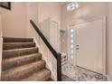 Welcoming foyer with coat closet, tiled floor detail and staircase leading to the main living area at 2061 S Worchester Way, Aurora, CO 80014