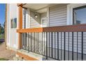 Close-up shot of front door and porch area with metal railing and muted-brown accents at 8450 Decatur St # 97, Westminster, CO 80031